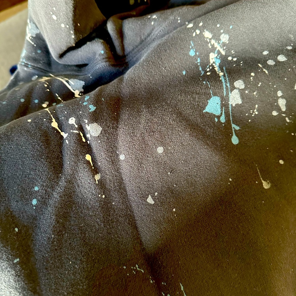 Black Abercrombie men’s hoodie with paint splatter design